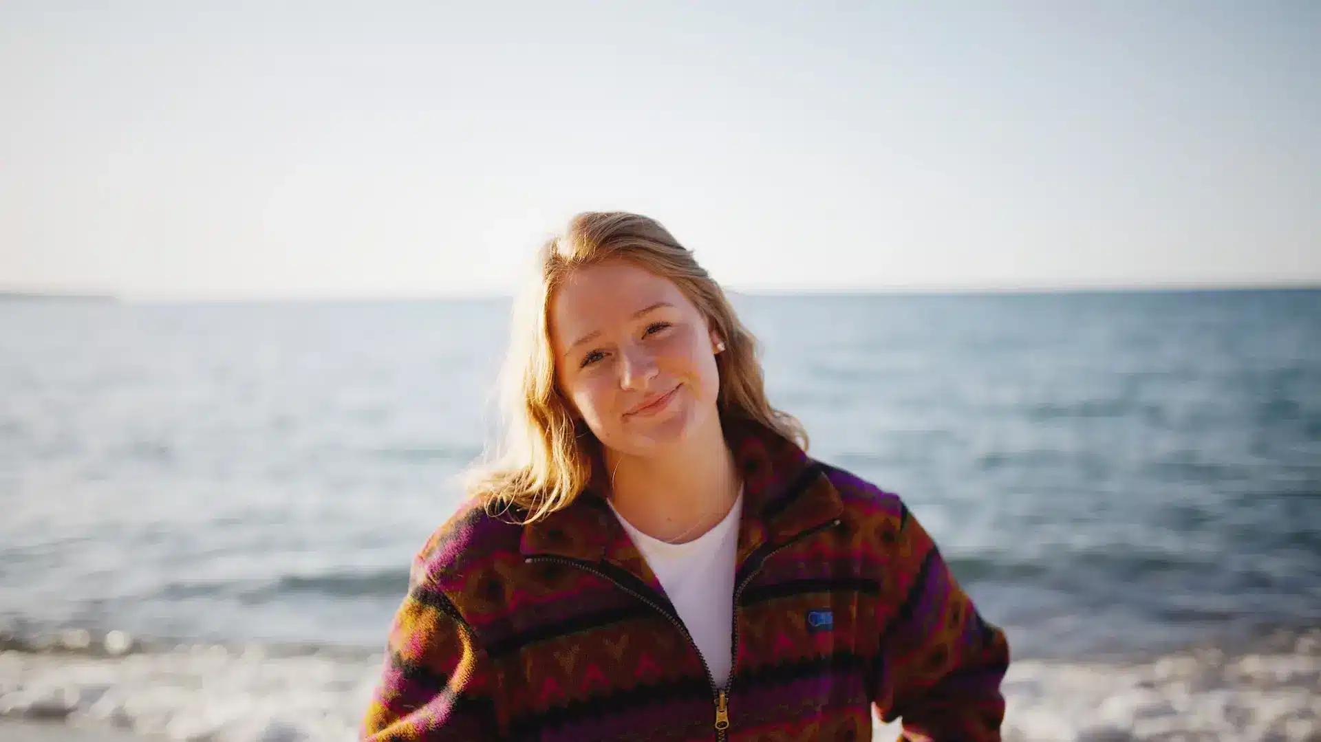 hypnosis, hypnotherapy, health A young woman smiling at the ocean.