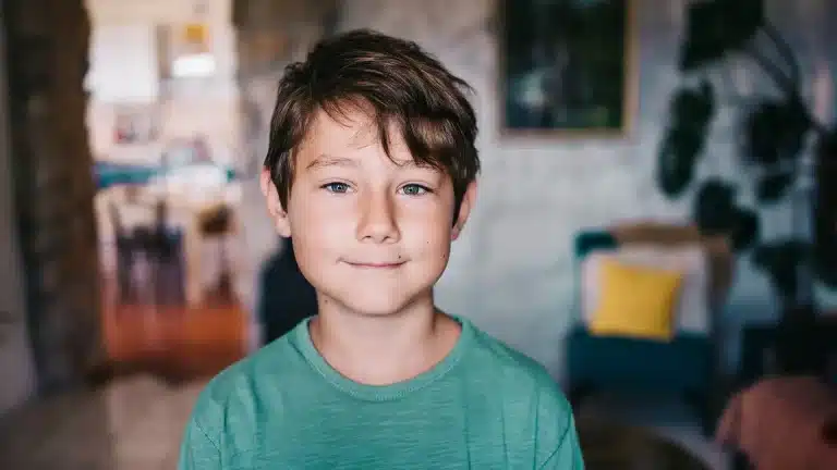 hypnosis, hypnotherapy, health A boy in a green shirt is standing in a living room.