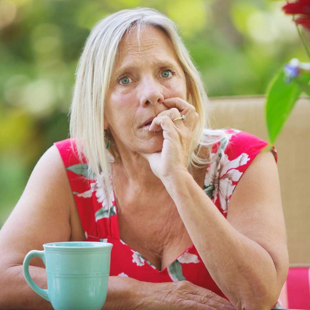 Close-up of fingers near mouth, illustrating nail-biting urge addressed by hypnotherapy