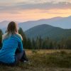 Person climbing mountain, symbolising overcoming limiting beliefs through self-hypnosis