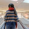 Woman facing fear on escalator through self-hypnosis techniques