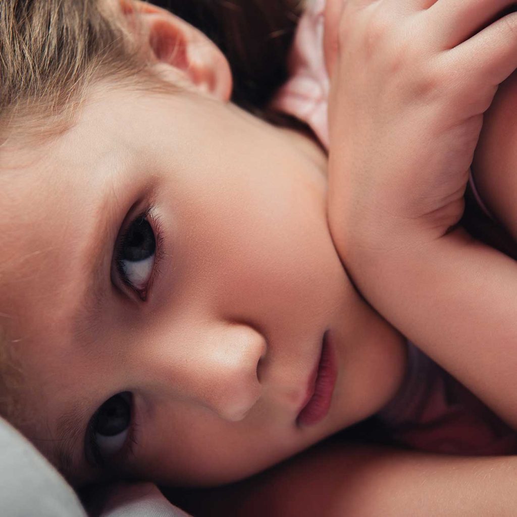 Child comfortably sleeping, demonstrating self-hypnosis for sleep improvement.