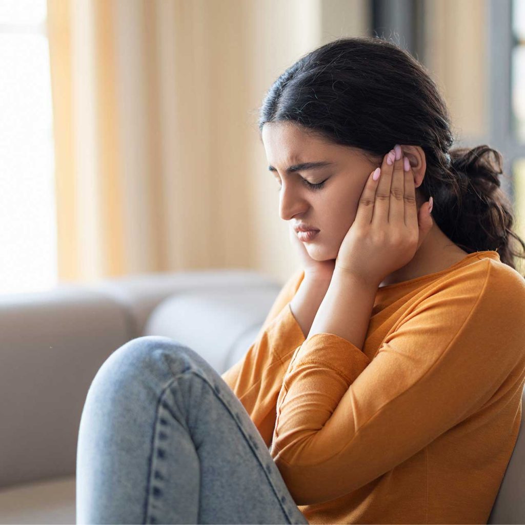 Serene woman meditating, representing misophonia management through self-hypnosis