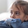 Close-up of anxious child's face, illustrating youth mental health concerns